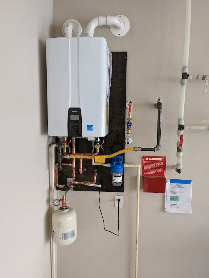 Professional plumber installing copper piping in a Sauk Centre home